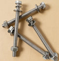 Metal bolts with nuts on a beige background｜card